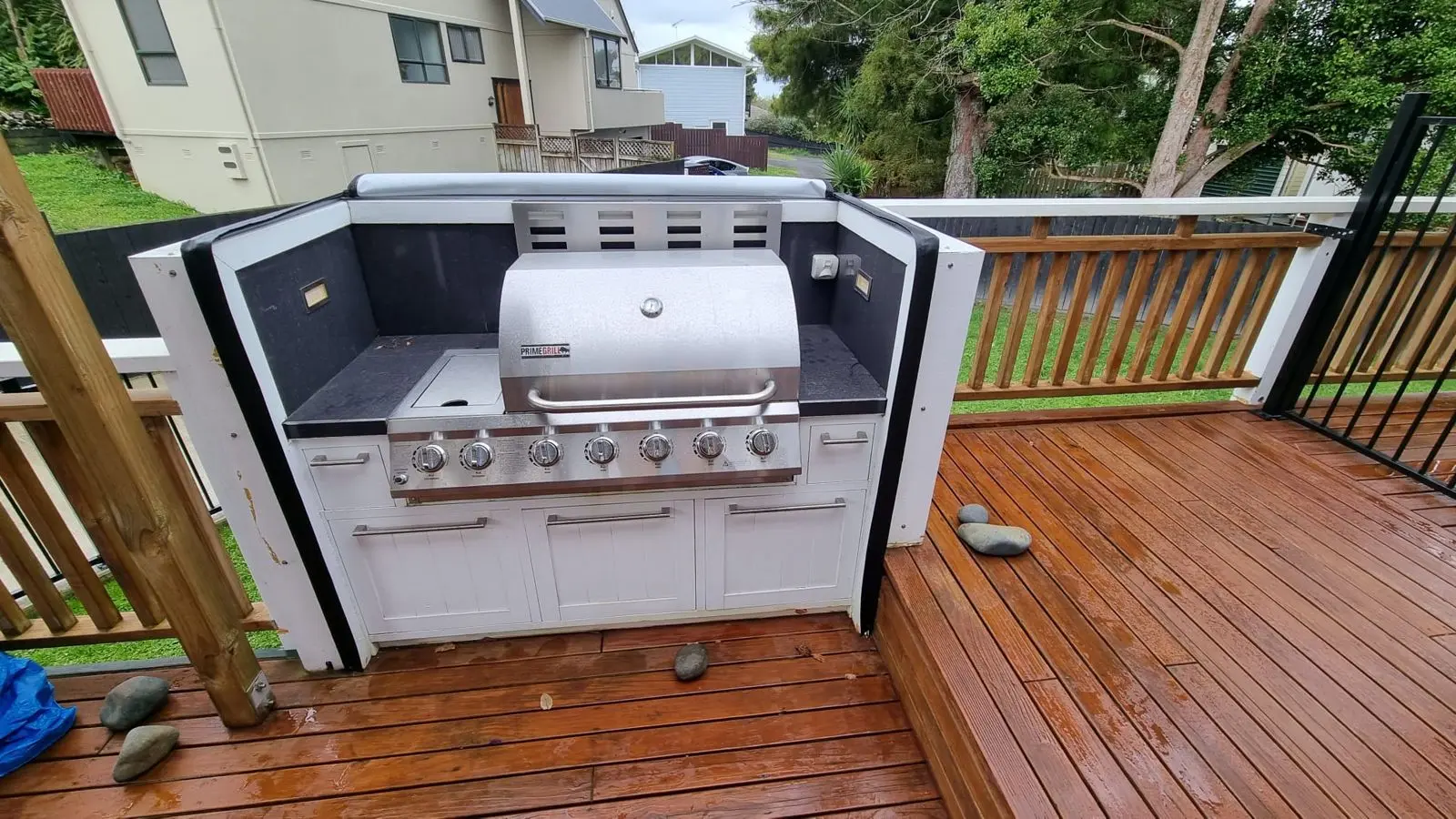 Built-in BBQ exposed to the weather on a timber deck