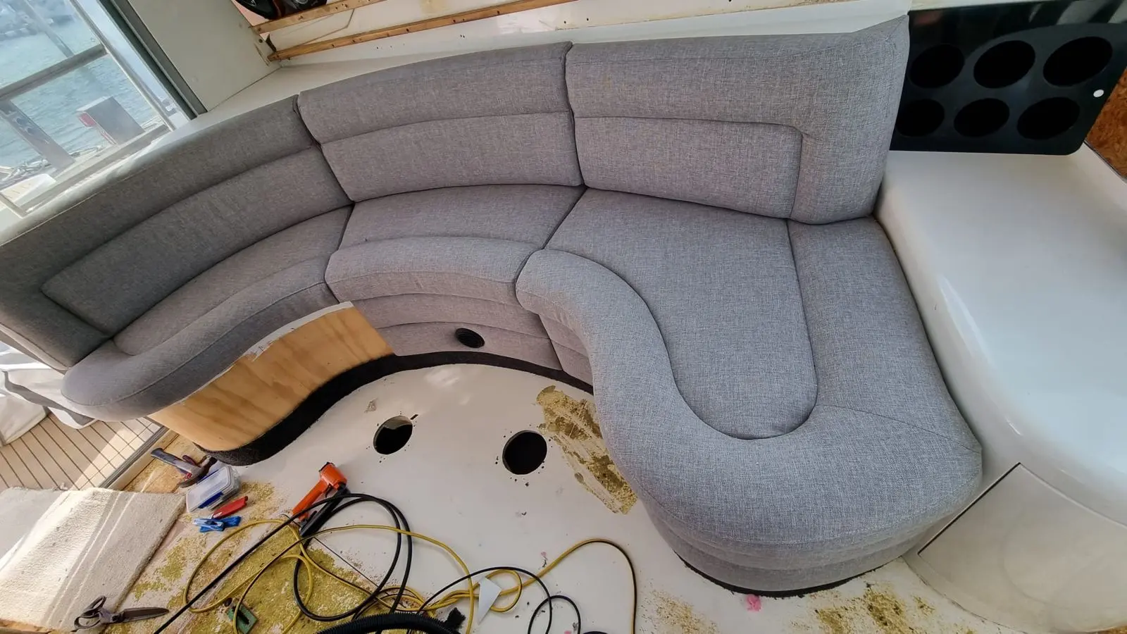 Curved launch saloon seating recovered in grey tweed
