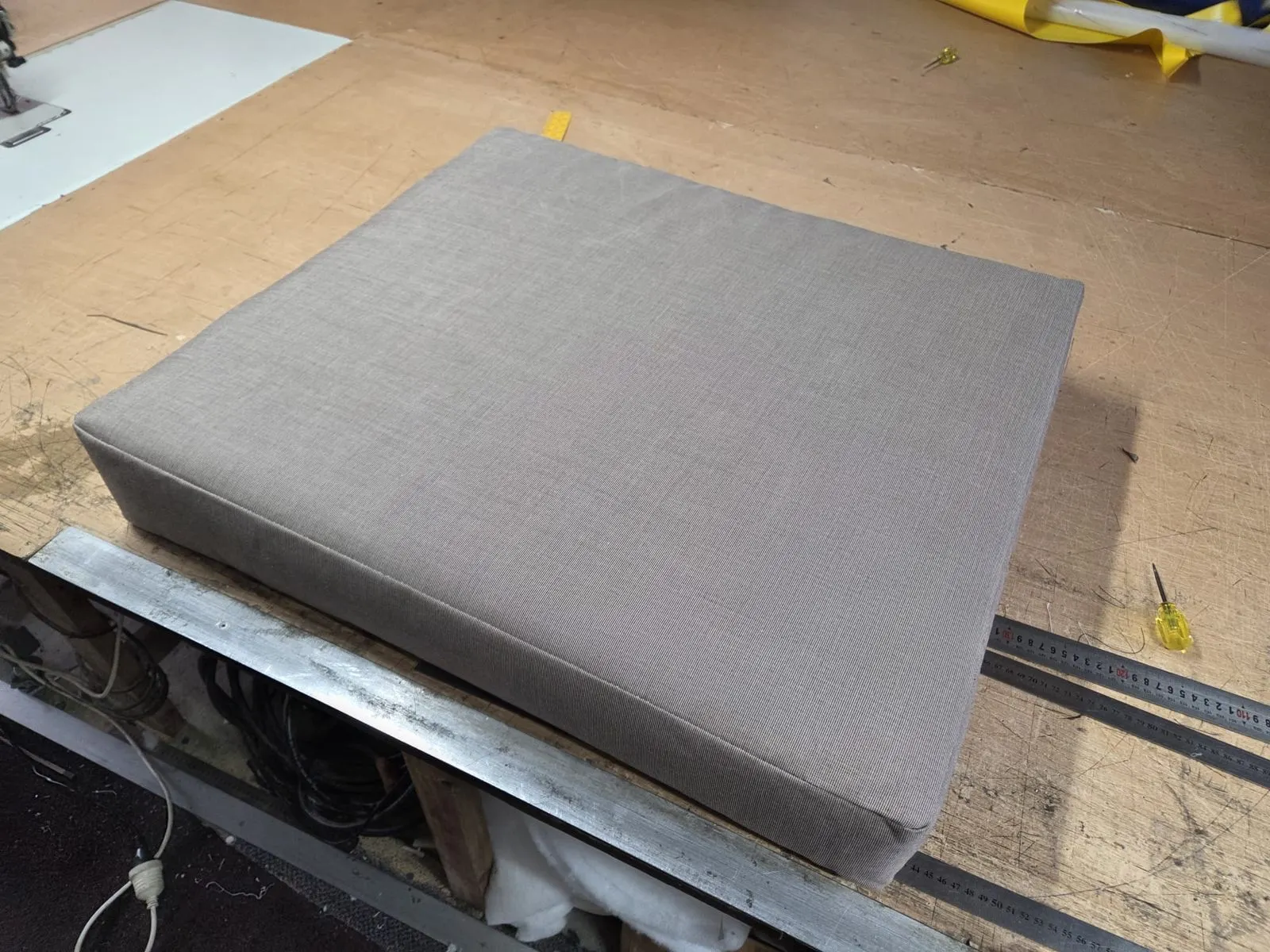 Squab recovered in fresh outdoor fabric on the workshop bench