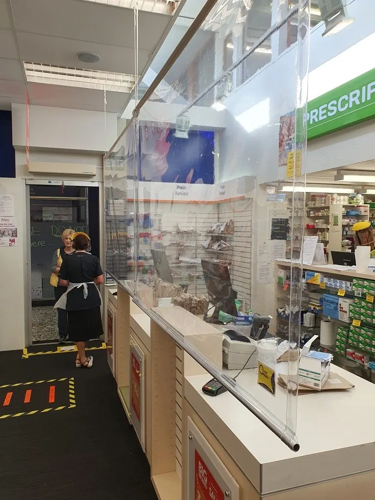 Clear PVC protective screens installed in a pharmacy