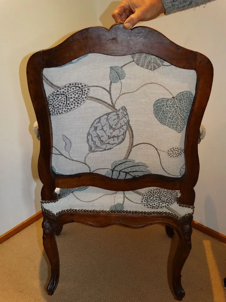 Detailed upholstery work on the back of a restored antique chair