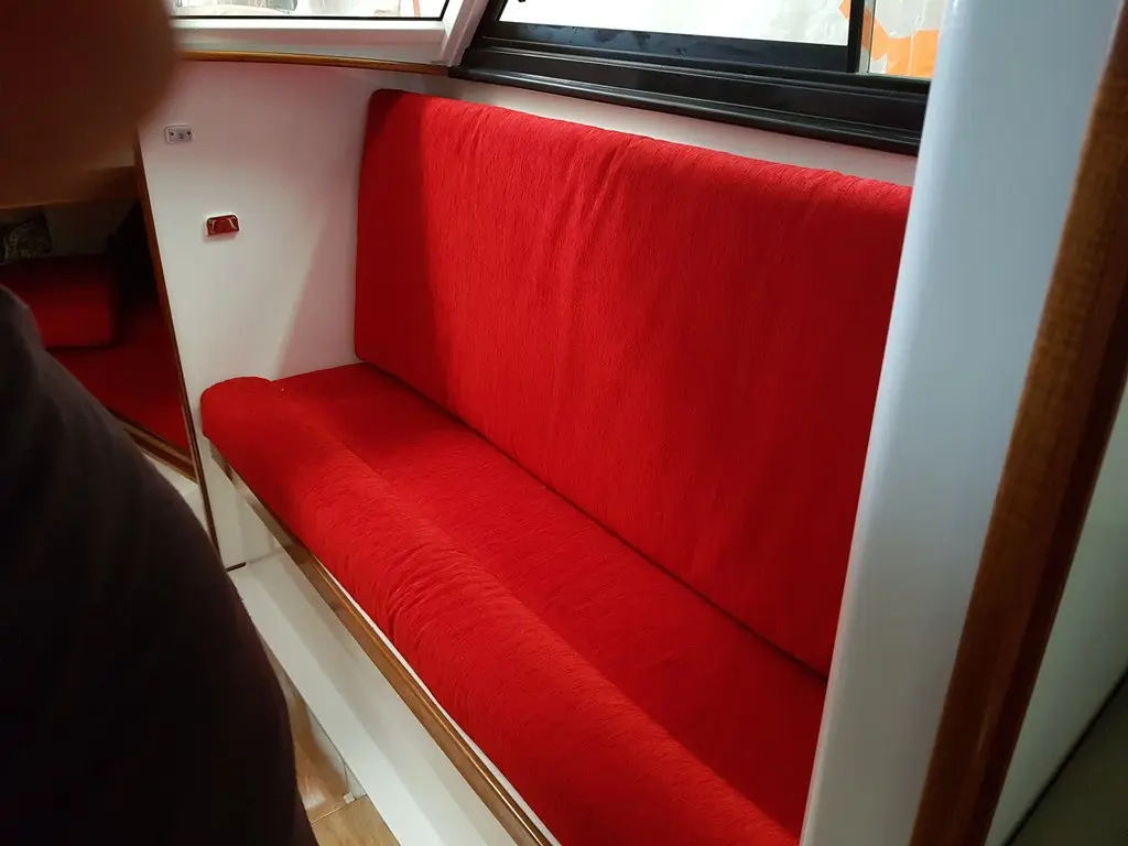 Red upholstered saloon seating in a boat