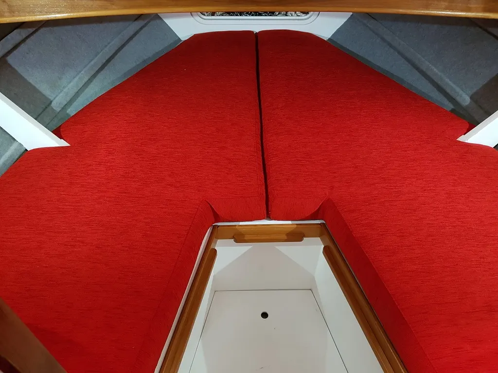 Custom red marine squabs fitted in a boat cabin