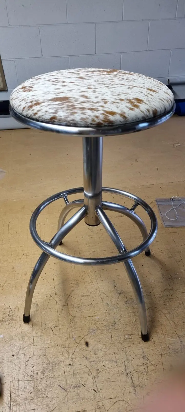 Bar stool recovered in white and tan cowhide