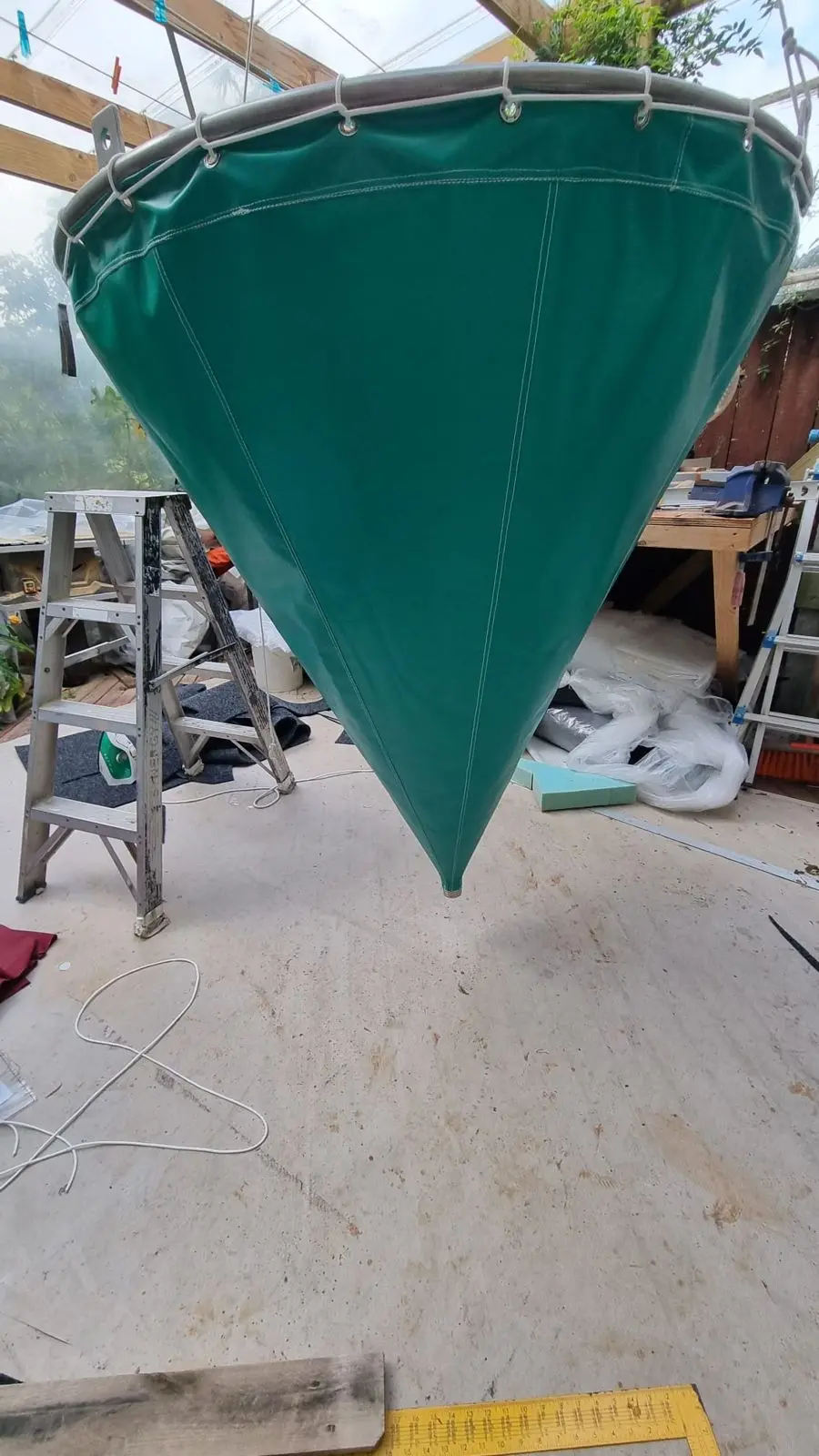 Green PVC cone cover made for an industrial hopper