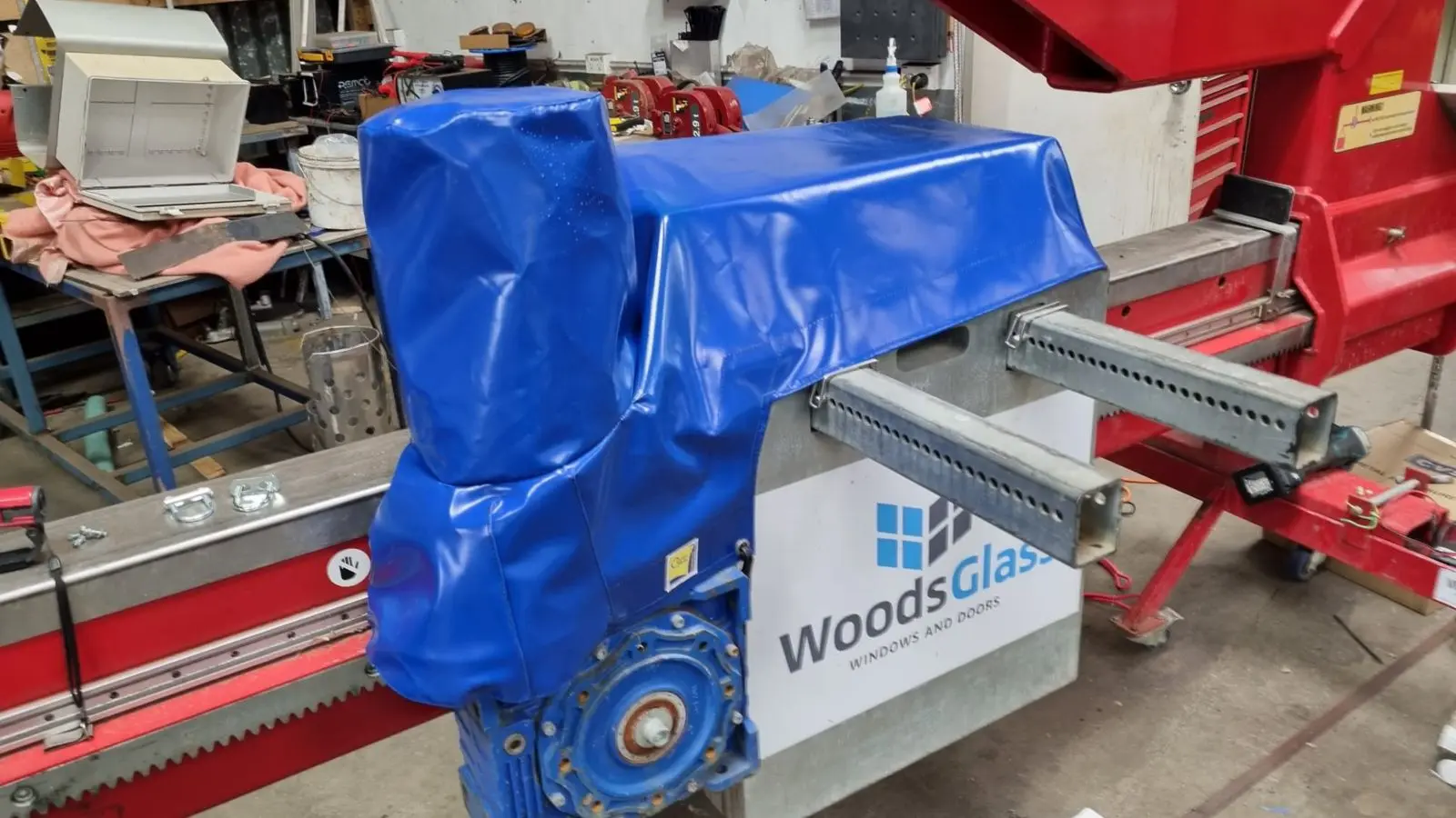 Blue PVC cover fitted over factory glass machinery